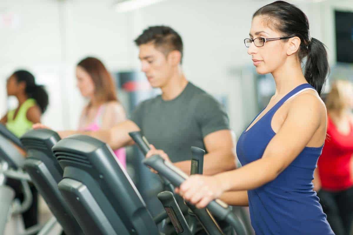 Image of people on an elliptical trainer.