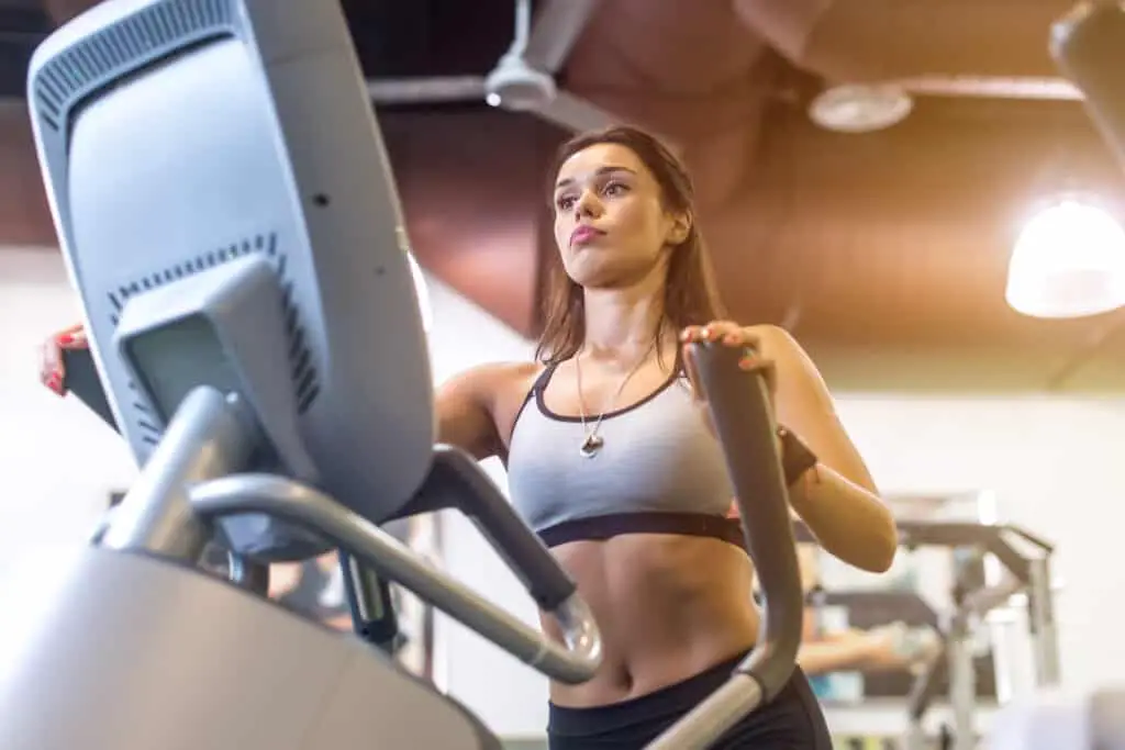 Image of a woman working out on an elliptical trainer.