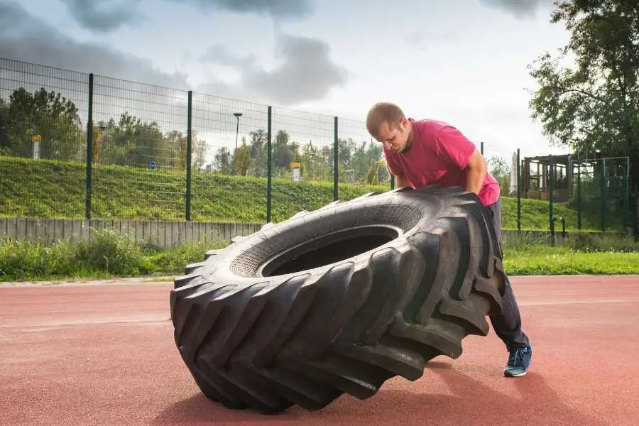 Image of a man flipping a heavy tire.