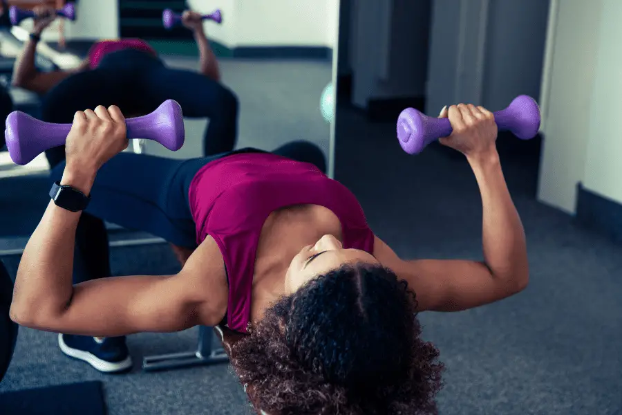 Image of a woman performing a dumbbell press