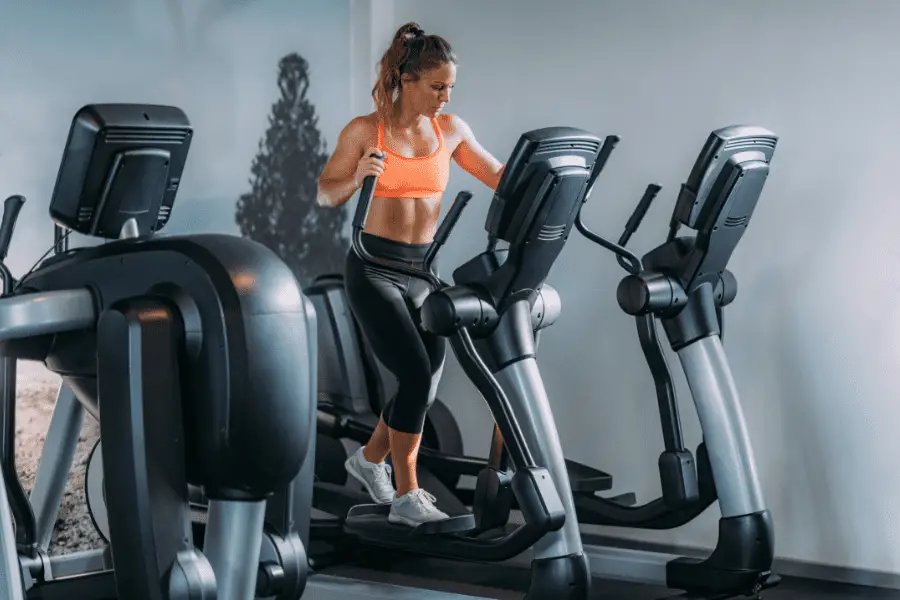 Image of a woman using an elliptical trainer.