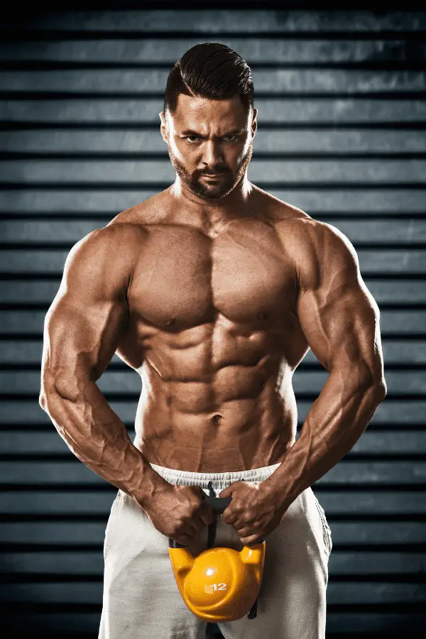 Image of a muscular man holding a kettlebell