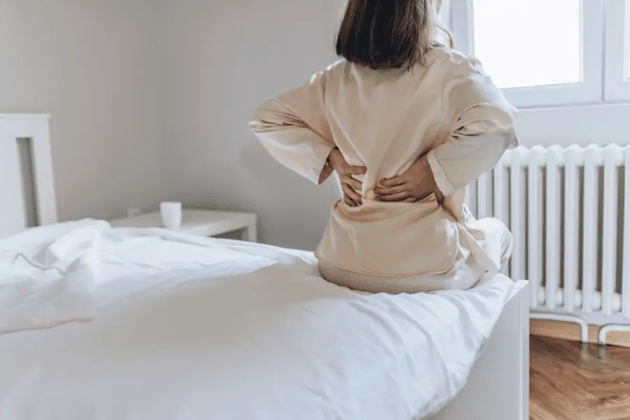 Woman with painful back in bed