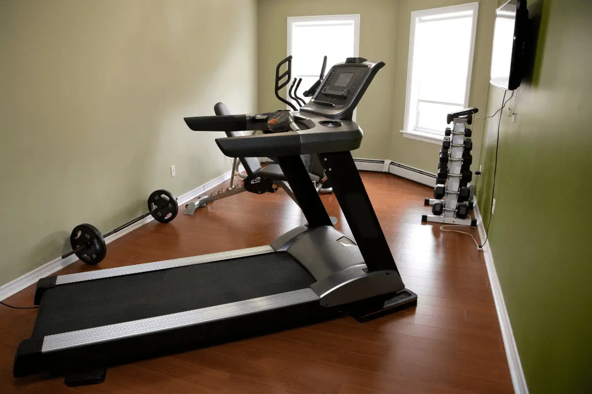Image of a treadmill and weights in an apartment.
