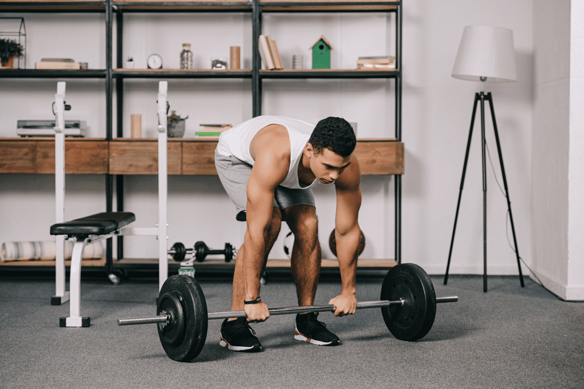Image of a man deadlifting in the living room.